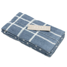 Load image into Gallery viewer, Folded blue checkered towel with a beige label on a white background
