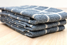 Load image into Gallery viewer, Stack of blue and white checkered towels on a wooden surface
